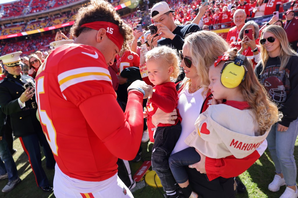 Patrick Mahomes #15 of the Kansas City Chiefs fist bumps his son, Bronze, while his wife and daughter, Brittany and Sterling, watch prior to a game against the Denver Broncos at GEHA Field at Arrowhead Stadium on November 10, 2024 in Kansas City.