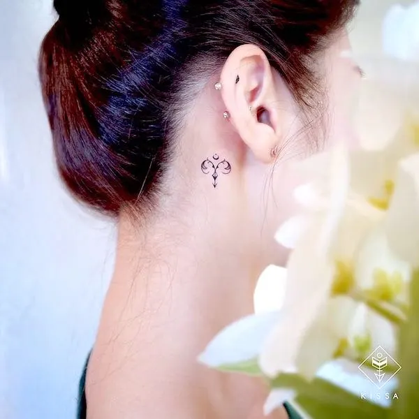 Tiny behind-the-ear Aries tattoo by @kissa.tattoo