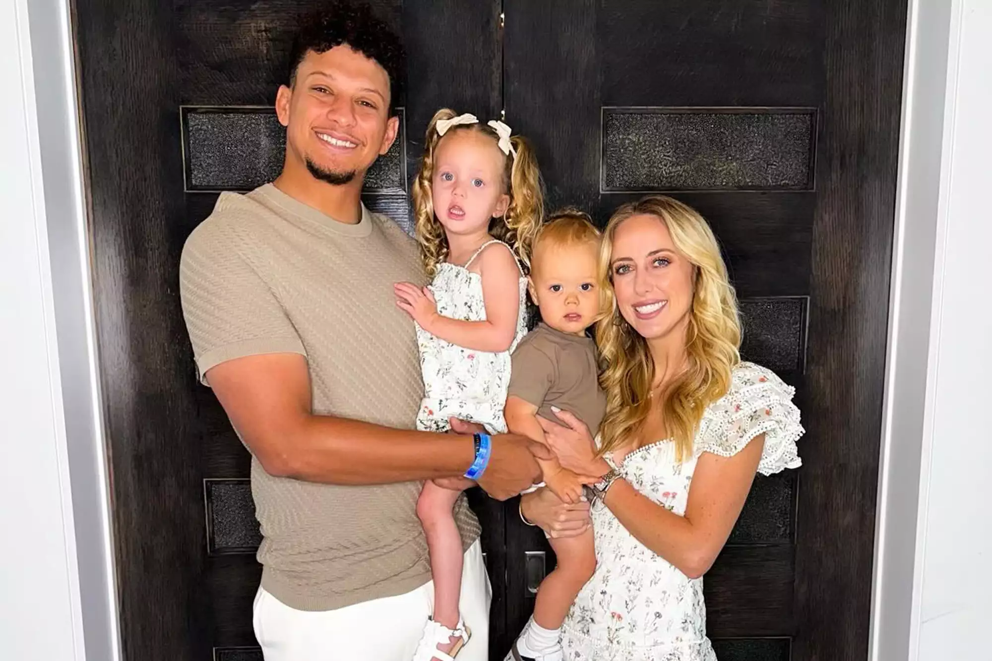 Patrick Mahomes smiles with wife Brittany Mahomes and their two children in May 2024.