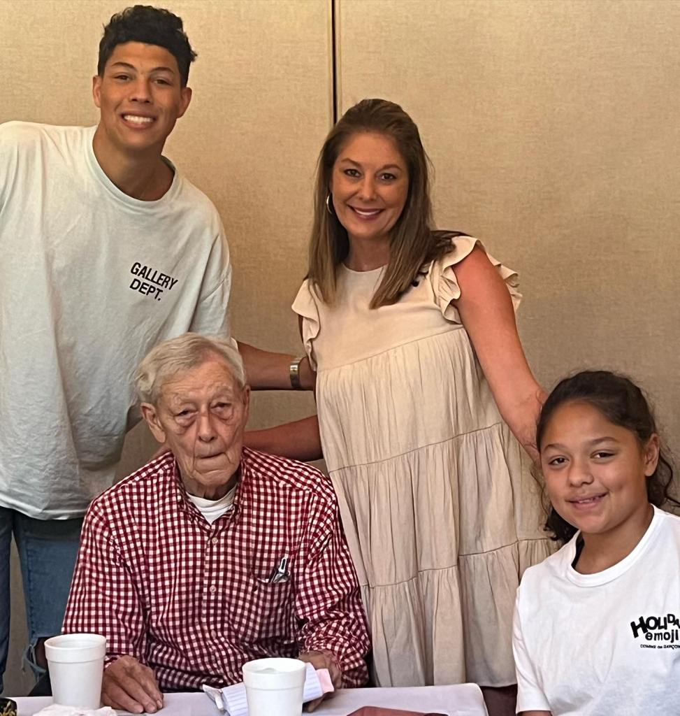 Patrick Mahomes' mom and grandfather pose in a picture together.