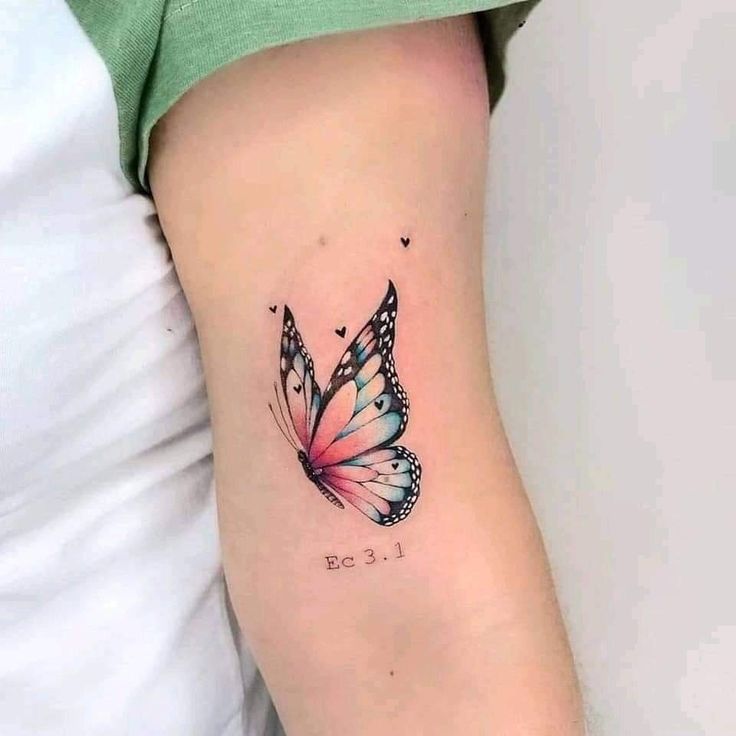 This may contain: a small butterfly tattoo on the arm