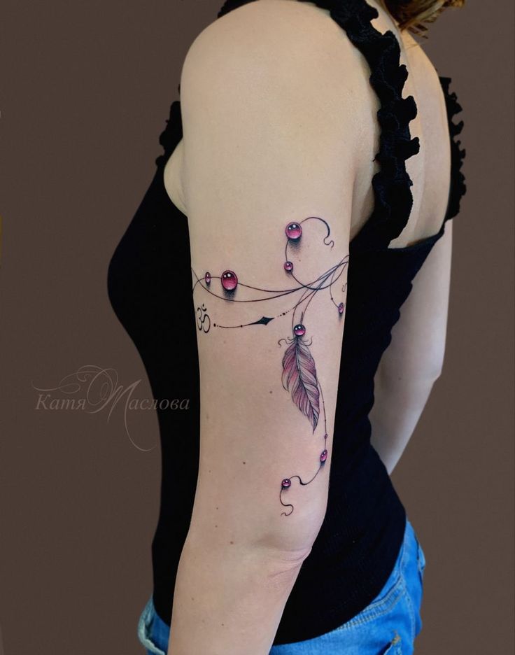 This may contain: a woman with a tattoo on her arm