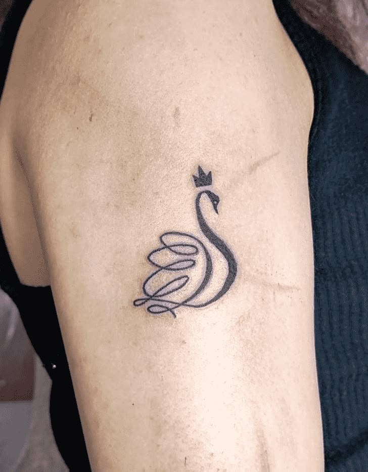 This may contain: a woman's arm with a tattoo on it that has a bird in the middle