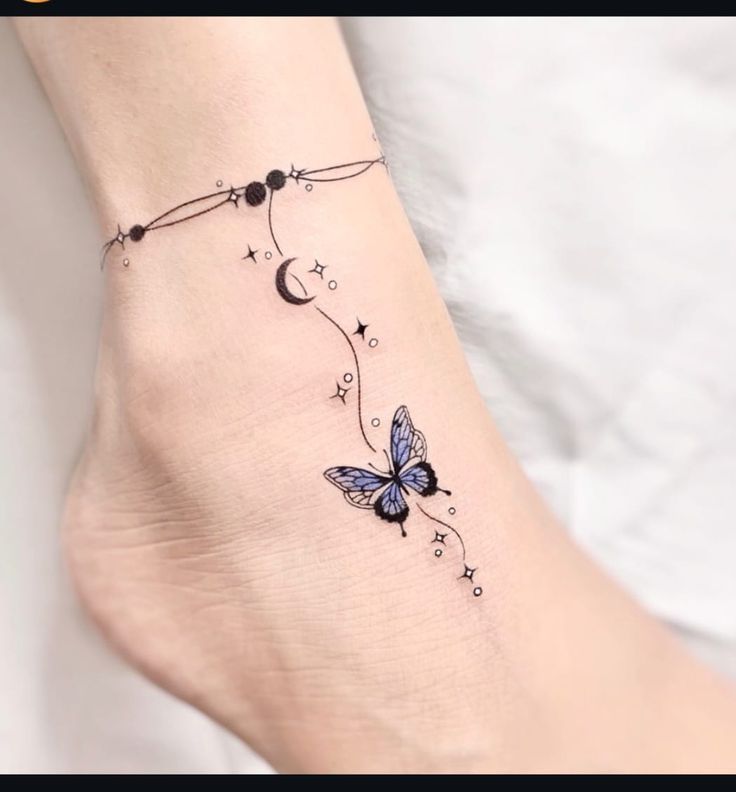 This may contain: a small butterfly tattoo on the ankle with stars and crescent moon tattoos are very attractive