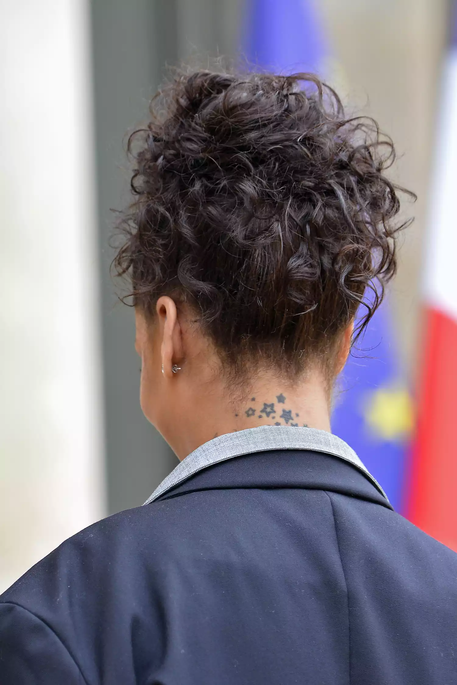 Back of Rihanna's head showing her tiny tattoos of stars