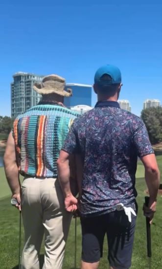 Two men on a golf course.