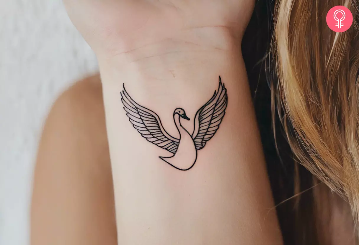 Minimalist swan tattoo on the arm