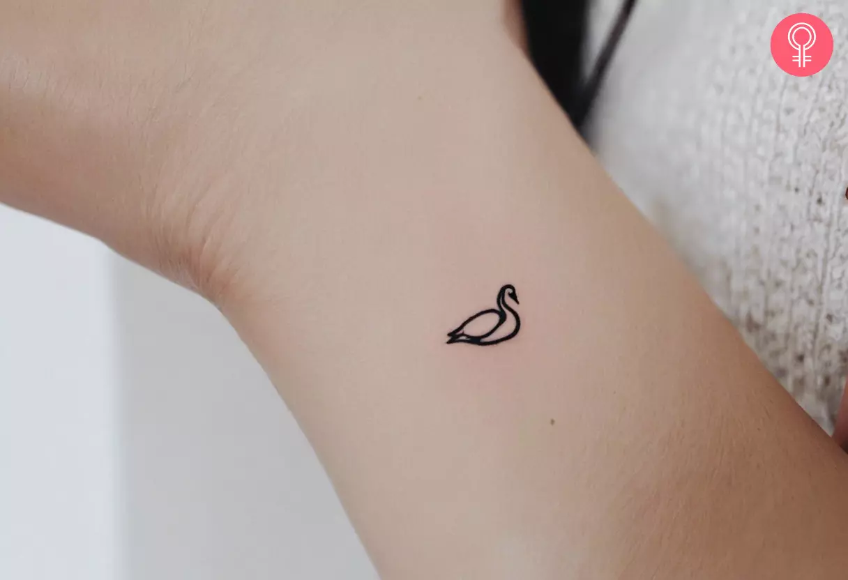 Small swan tattoo on the forearm