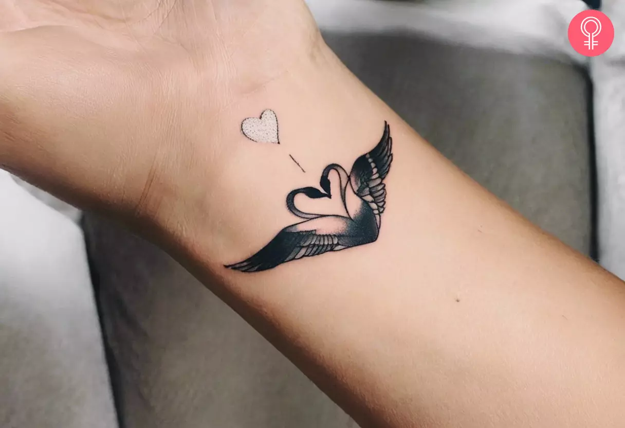 Swan heart tattoo on the wrist