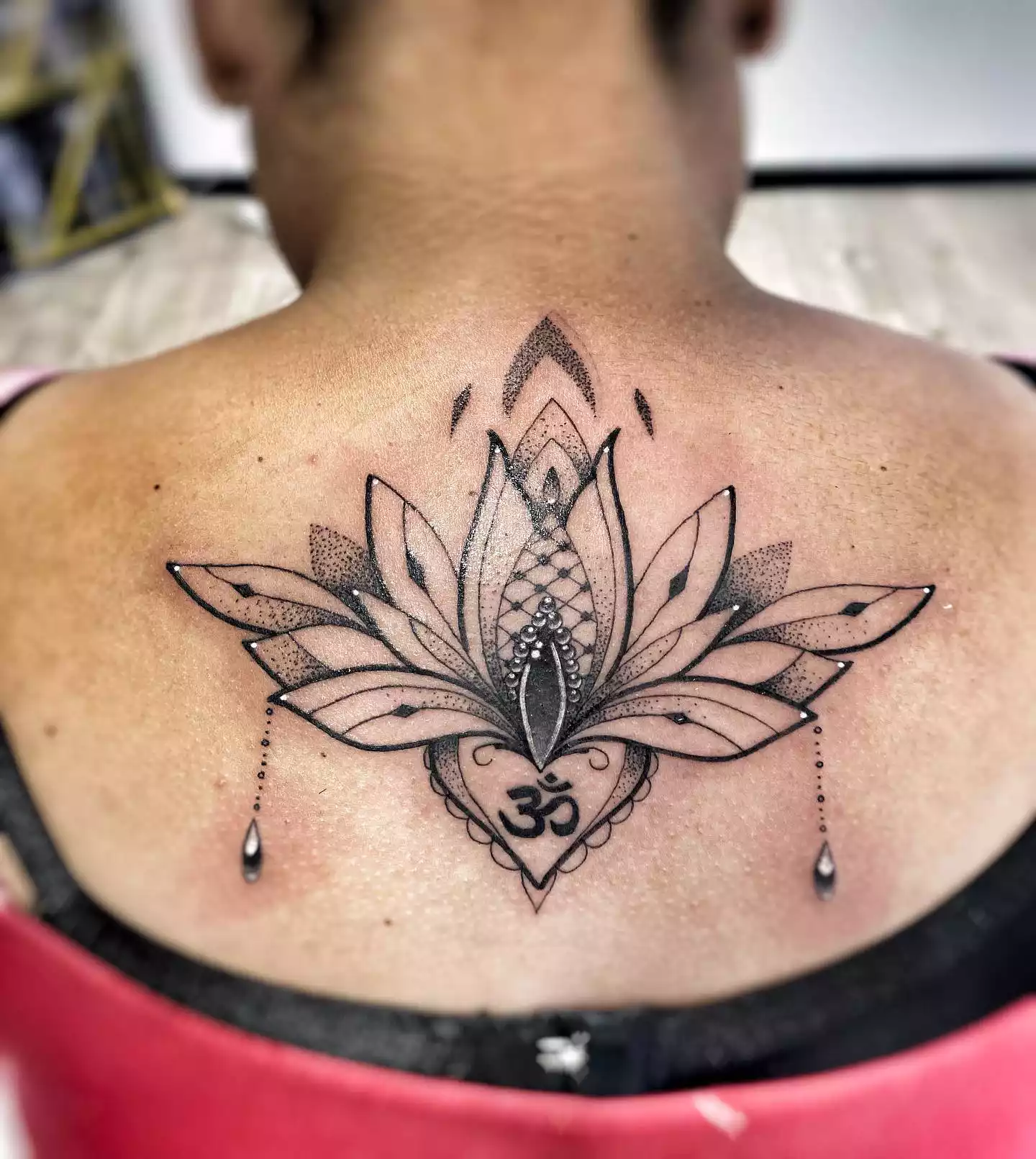 Image of a large lotus tattoo design with shading on someone's back