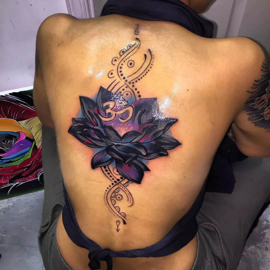 Image of a colorful lotus tattoo design taking up a person's entire back